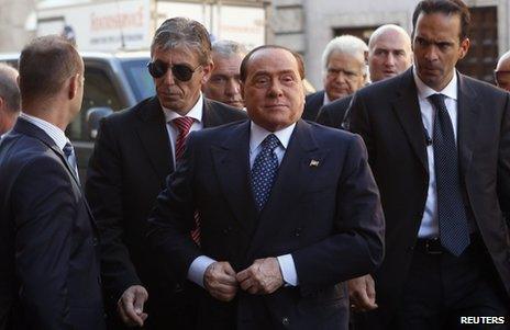 Silvio Berlusconi (foreground) arrives at the Senate in Rome, 2 October