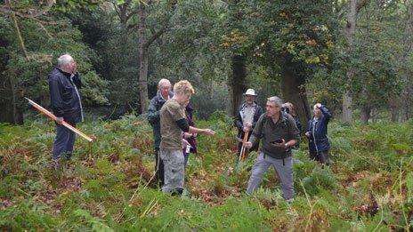 Steve Fisher with the volunteers surveying an inclosure