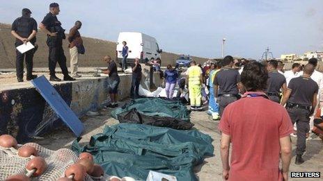 Body bags containing African migrants, who drowned trying to reach Italian shores, lie in the harbour of Lampedusa