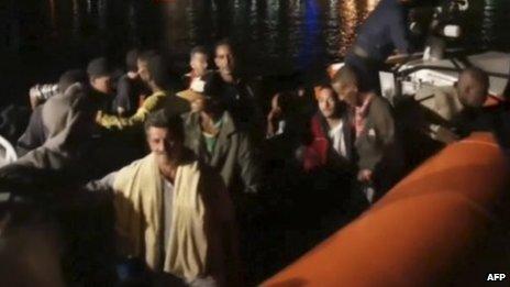 Survivors of a ship carrying migrants which caught fire and sank off the Sicilian island of Lampedusa are seen aboard an Italian Coast Guard vessel