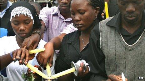 Ugandans who lost relatives light candles as they mark the first anniversary on 11 July 2011 two bars were bombed in the Ugandan capital and killed 76 people