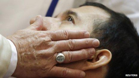 Pope Francis blesses a disabled person during his visit at the Serafico Institue in Assisi on 4 October 2013.