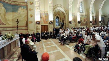 Pope Francis attends a meeting with disabled persons during his visit at the Serafico Institute in Assisi on 4 October 2013.