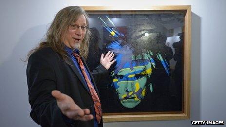 Matt Wrbican, Chief Archivist at The Andy Warhol Museum with one of the artist's self portraits