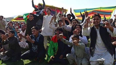 Afghanistan fans, watching on a big screen in Kabul, celebrate their team reaching the World Cup for the first time