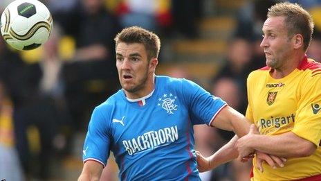 Andy Little holds off Albion Rovers opponent Ciaran Donnelly