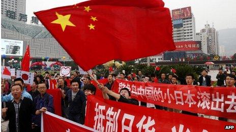 Chinese demonstrators carry Chinese national flags and shout slogans during a protest over the Diaoyu islands issue, known as the Senkaku islands in Japan, in Lanzhou, northwest China's Gansu province on 16 September 2012