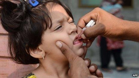 A Pakistani child receives an oral polio vaccine during an anti-polio campaign in Rawalpindi on 1 October 2013