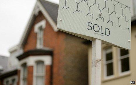 House with sold sign