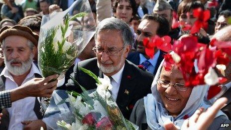 Afghan politician and former minister of foreign affairs, Zalmai Rassoul (C), leaves after registering for the forthcoming presidential elections at the Independent Election Commission (IEC) in Kabul on October 6, 2013.