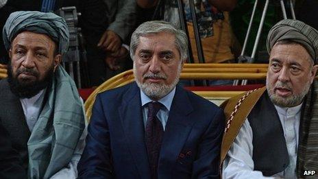 Afghan politician, Abdullah Abdullah (C) sits with his two vice-presidential candidates, Mohammed Mohaqiq (R) and Mohammad Khan (L) during a registration process for the forthcoming presidential elections at Independent Election Commission (IEC) in Kabul on October 1, 2013.