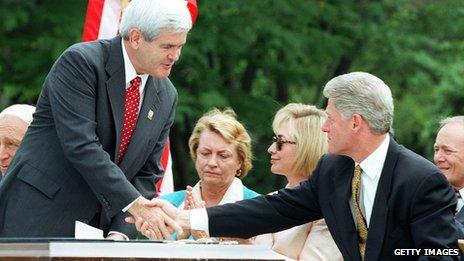 US Speaker of the House Newt Gingrich shakes hands with US President Bill Clinton