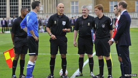 Referee Howard Webb tosses the coin before the match