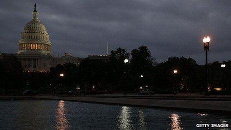 The US Capitol is lit under dark clouds on the morning of October 7.