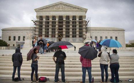 Protesters stand outside the US Supreme Court on 7 October 2013