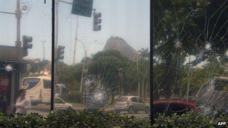 Smashed windows of Angola's consulate, vandalized by demonstrators on Monday night in Rio de Janeiro