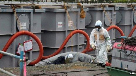 Tokyo Electric Power Co (Tepco) workers work on waste water tanks at Japan's Fukushima Dai-ichi nuclear plant in the town of Okuma, Fukushima prefecture in Japan on 12 June 2013