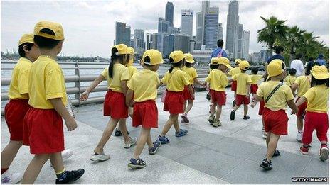 School children walking in a crocodile in Singapore