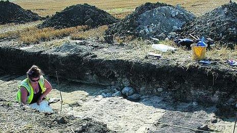 Archaeologist working a trench