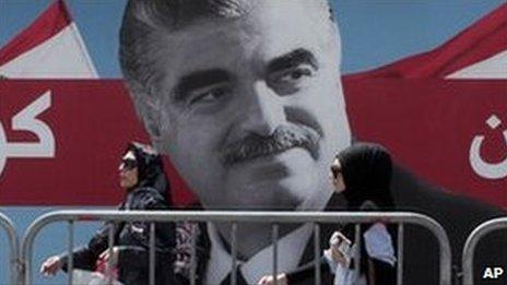 Women pass by a giant portrait of former Lebanese Prime Minister Rafik Hariri near his grave, Beirut, Lebanon. File photo