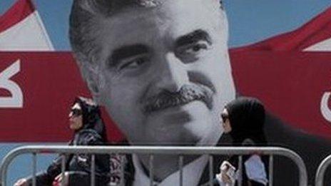 Women pass by a giant portrait of former Lebanese Prime Minister Rafik Hariri near his grave, Beirut, Lebanon. File photo