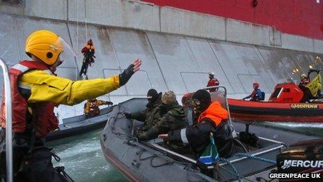 Boats from Greenpeace approach a Russian oil rig as officials try to stop them