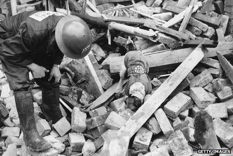 A wire-haired terrier operating with the PDSA (People's Dispensary for Animals) rescue party, on the scent for an animal buried in the rubble of a wrecked building 1941