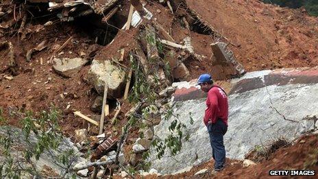 A rescuer surveys the mudslide near La Pintada