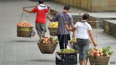 Vendors carrying food items in China