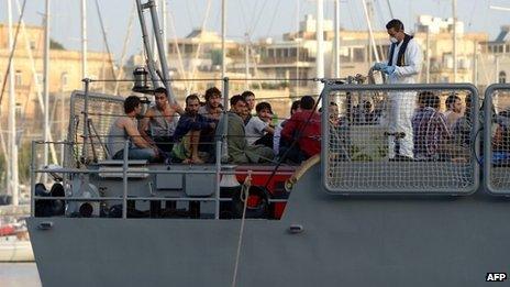 Migrants arrive at Hay Wharf in Valletta aboard a patrol boat of the Armed forces of Malta on October 12, 2013, a day after their boat sank. More than 140 survivors, plucked from the sea after their overloaded boat sank in the latest deadly migrant tragedy to hit the Mediterranean, arrived in Malta.