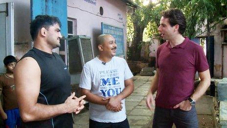 Deepak Prasad (middle) chats with the BBC's Mark Beaumont (right) and wrestling champion Naveen Mor.