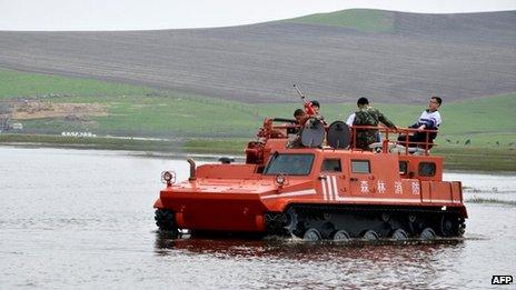 Crossing flooded land to get pupils to exam, June 2013