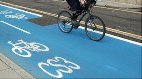 Person riding a bicycle on a Barclays Cycle Superhighway