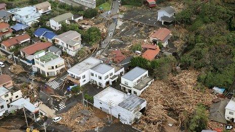 Several houses in a residential area are covered by debris from mudslides after a powerful typhoon hit Izu Oshima island on 16 October 2013