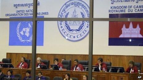 File photo released by the Extraordinary Chambers in the Courts of Cambodia, court officers of the UN-backed war crimes tribunal are seen through windows during a hearing of former Khmer Rouge top leaders in Phnom Penh, Cambodia