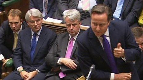 David Cameron, with Andrew Mitchell watching on