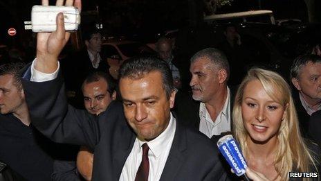 Front National Front party candidate Laurent Lopez (L) waves to supporters as he arrives with French National Front party deputy Marion Marechal-Le Pen (R) after winning the second round of the local by-election in Brignoles on 13 October 2013