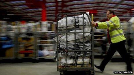 A Royal Mail worker in sorting office