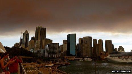 Smoke and ash from wildfires burning across the state of New South Wales blankets the Sydney city skyline on October 17, 2013