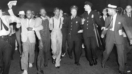 1937 file photo, police escort two of the five recently freed Scottsboro Boys