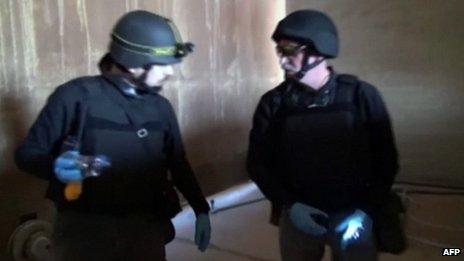 An image grab taken from Syrian television shows inspectors from the Organisation for the Prohibition of Chemical Weapons (OPCW) at work at an undisclosed location in Syria on 10 October 2013