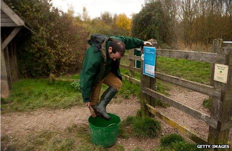 Woodland Trust worker disinfects his boots at Pound Farm Woodland