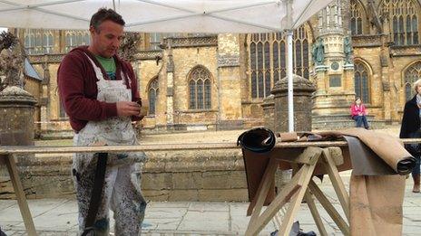 Set painter Andy Armstrong working outside Sherborne Abbey ahead of filming