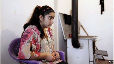 Leonarda Dibrani sits at her home with her family members in the town of Mitrovica, Kosovo, 16 October