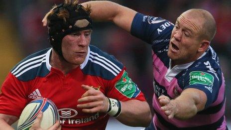 Munster's Niall Ronan is tackled by Gloucester Mike Tindall