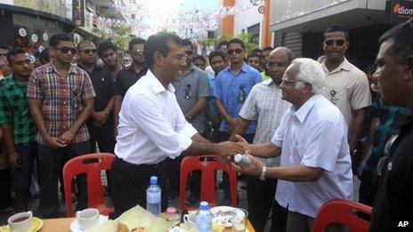 Mr Nasheed (centre) shakes hands with a supporter during a protest in Male. Photo: 19 October 2013