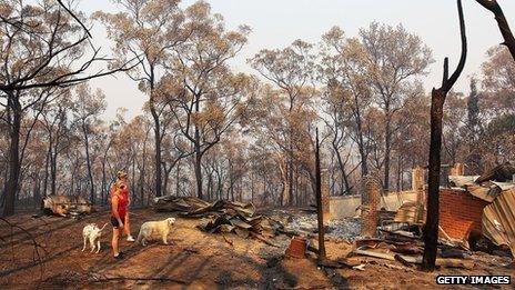 Melissa White assists her sister Christie Daschke at her home in Winmalee destroyed by bushfire on 21 October 2013