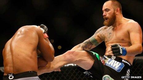 Travis Browne kicks Alistair Overeem in their heavyweight bout in August