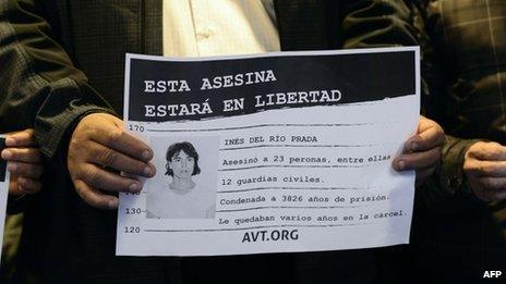 An activist holds a placard which reads "This murderer will be free", alongside a picture of Ines Del Rio