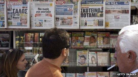 People walk past newspapers on a stand which feature front pages reporting on the story a four-year-old girl Maria, 21 October